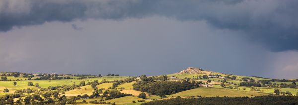 Almscliff Crag with rain storm approaching.